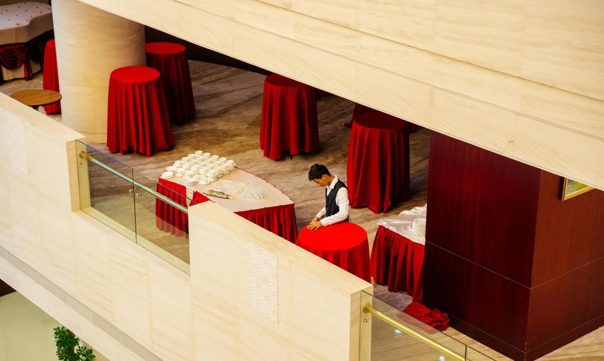 Beijing Palace Soluxe Hotel Astana Bagian luar foto A hotel staff sets up a cocktail reception